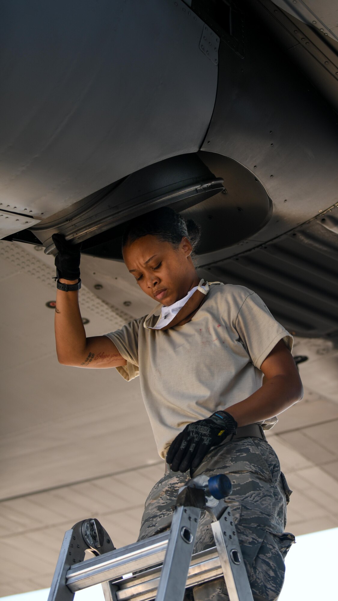Senior Airman Dayna Jones, a crew chief with the 910th Maintenance Squadron, steps down from a ladder after performing a thru-flight inspection on a C-130H Hercules on Youngstown Air Reserve Station’s flightline, July 7, 2020. Crew chiefs use thru-flight inspections to search for any loose, broken or corroded parts and foreign material prior to takeoff.