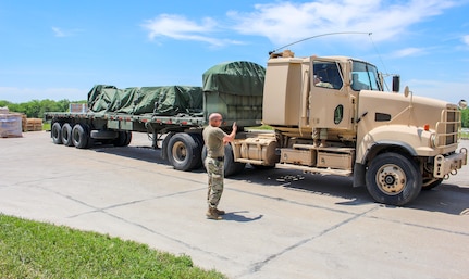 Nebraska Army National Guard Soldiers move personal protective equipment from a warehouse June 2, 2020, in Lincoln, Nebraska. The Nebraska National Guard delivered PPE across the state to all the local health departments.