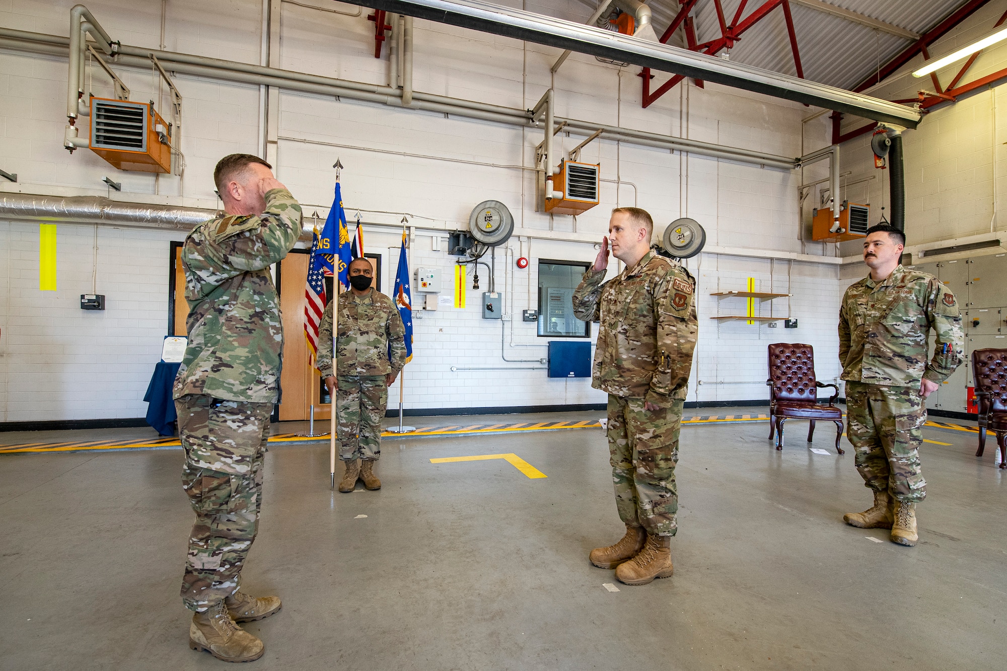 U.S. Air Force Maj. Kenneth French, center right, 420th Munitions Squadron (MUNS) outgoing commander, relinquishes command of the 420th MUNS to Col. Jon T. Hannah, left, 422d Air Base Group commander, during a change of command ceremony at RAF Welford, England, July 10, 2020. The change of command ceremony is a military tradition that represents a formal transfer of a unit’s authority and responsibility from one commander to another. (U.S. Air Force photo by Senior Airman Eugene Oliver)