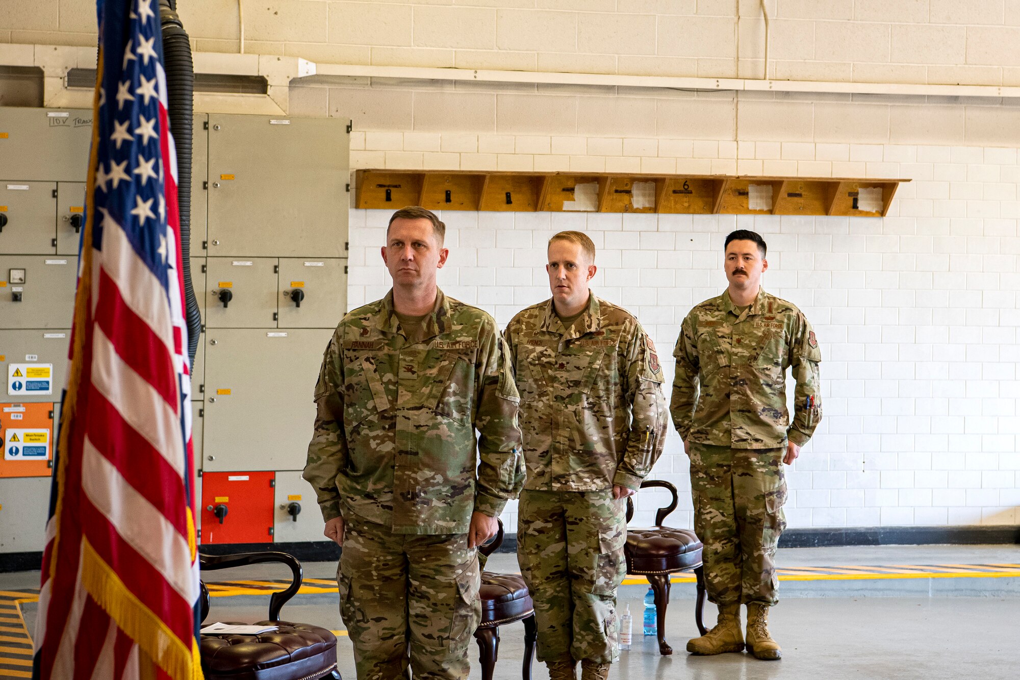 U.S. Air Force Col. Jon T. Hannah, left, 422d Air Base Group commander, Maj. Kenneth French, center, 420th Munitions Squadron (MUNS) outgoing commander, and Maj. Christopher Wood, right, 420th MUNS incoming commander, stand at attention for the playing of the national anthem during a change of command ceremony at RAF Welford, England, July 10, 2020. The change of command ceremony is a military tradition that represents a formal transfer of a unit’s authority and responsibility from one commander to another. (U.S. Air Force photo by Senior Airman Eugene Oliver)