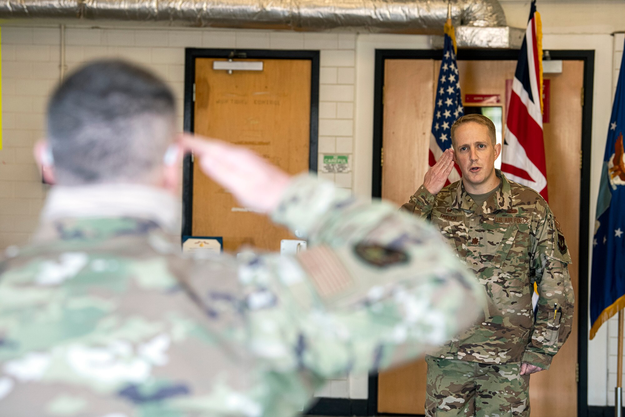 U.S. Air Force Maj. Kenneth French, 420th Munitions Squadron (MUNS) outgoing commander, renders a final salute during a change of command ceremony at RAF Welford, England, July 10, 2020. During the ceremony French relinquished command of the 420th MUNS to Maj. Christopher Wood. (U.S. Air Force photo by Senior Airman Eugene Oliver)