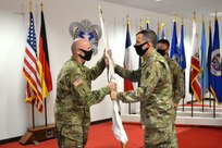 Col. Doug LeVien, right, passes the U.S. Army Medical Materiel Center-Europe's colors to incoming commander, Col. Shane Roach, during a Change of Command ceremony on July 9. Outgoing commander Col. Jonathan B. Butler is pictured on the right. LeVien, deputy commander of 21st Theater Sustainment Command, served as the representative for Col. Michael Lalor, commander of Army Medical Logistics Command. Lalor presided over the ceremony remotely from Fort Detrick, Maryland.