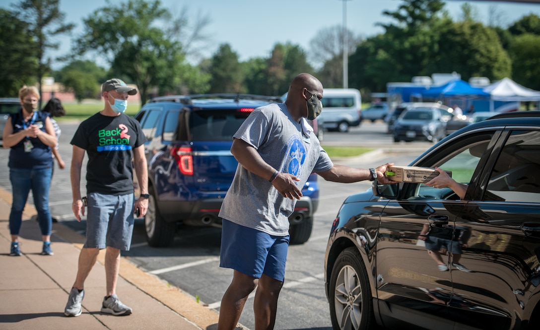 Volunteers hand out school supplies and backpacks at the Scott Air Force Base Operation Homefront Back-to-School Brigade school supplies distribution event, July 11, 2020, Scott Air Force Base, Illinois. (U.S. Air Force photo by Master Sgt. Christopher Parr)