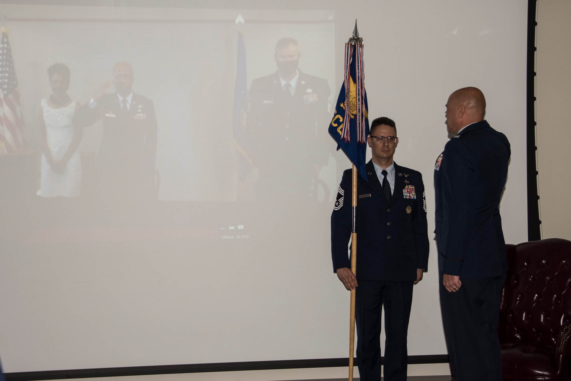 Airman salutes other Airman who is on screen.