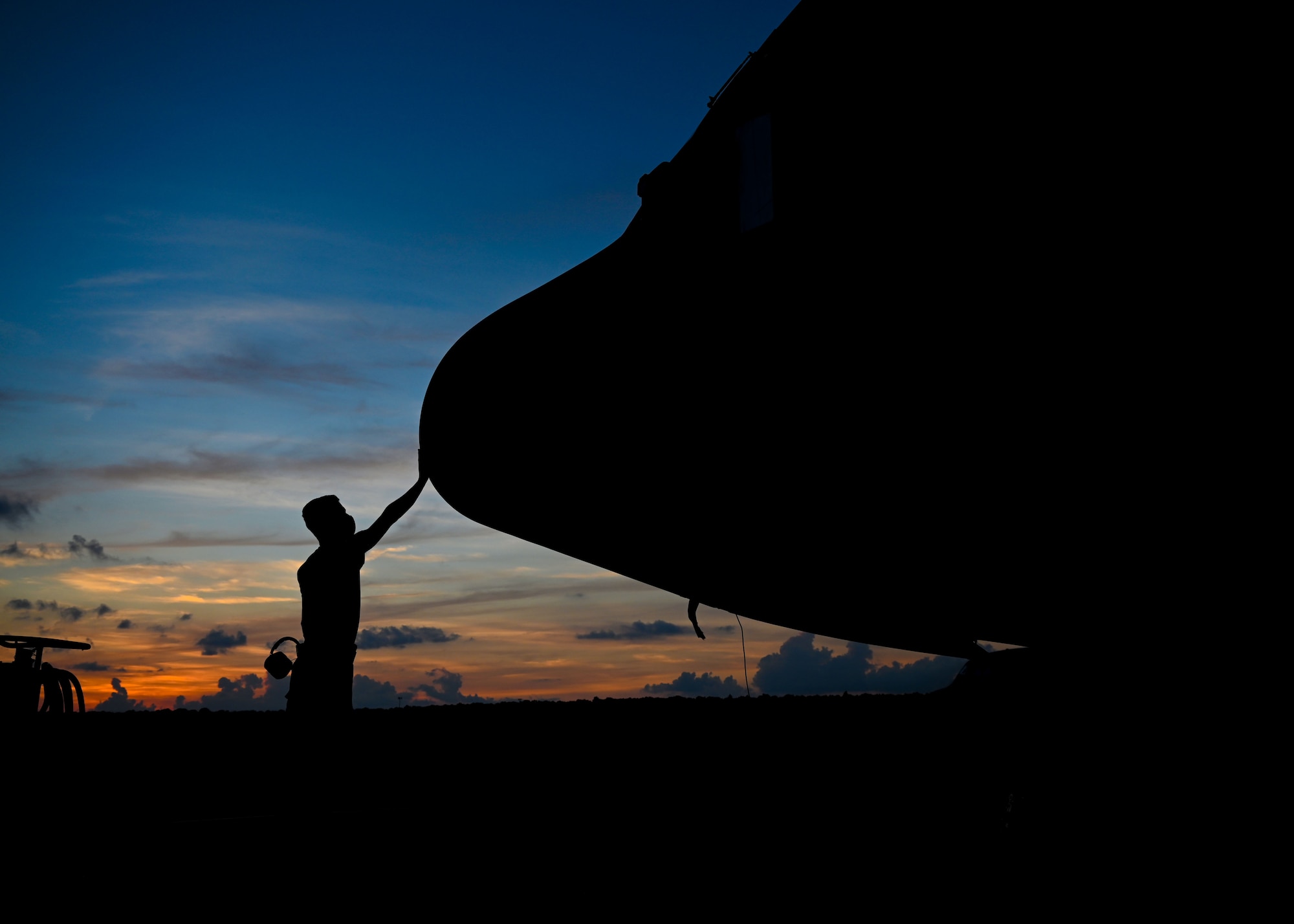 An Airman touches the nose of a C-130J Super Hercules.