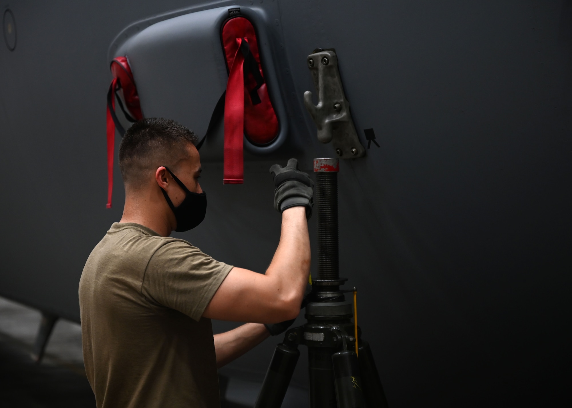 An Airman adjusts a tool.