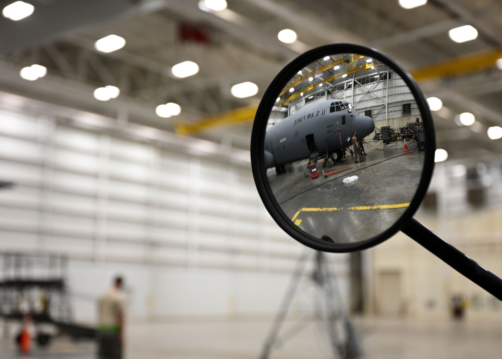 Airmen prepare a C-130J Super Hercules for maintenance.