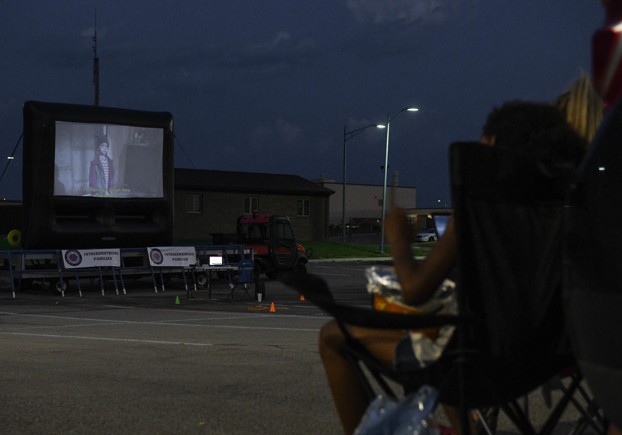 A Team Whiteman family member sits with her mom during a Base Community Council hosted drive-in movie event, at the Mission’s End Club on Whiteman Air Force Base, Missouri, July 11, 2020. The event showcased the strong community relationship between Team Whiteman and its surrounding 18 BCC communities. (U.S. Air Force photo by Staff Sgt. Sadie Colbert)