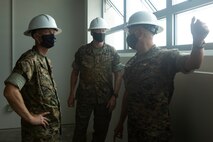 U.S. Marine Corps Col. Curtis Ebitz, commanding officer of Marine Corps Air Station New River, and Lt. Col. Roger Holliday, director of MCAS New River installations and environment, escort Maj. Gen. Edward D. Banta, commanding general of Marine Corps Installations Command, through hangar AS-215 on MCAS New River, July 13, 2020. Banta is visiting military installations in Eastern North Carolina to receive an update on military construction from installation leaders and view hurricane related repairs to facilities and family housing currently in progress. (U.S. Marine Corps photo by Sgt. Breanna Weisenberger)