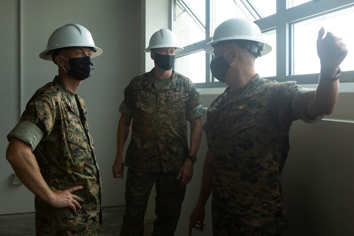 U.S. Marine Corps Col. Curtis Ebitz, commanding officer of Marine Corps Air Station New River, and Lt. Col. Roger Holliday, director of MCAS New River installations and environment, escort Maj. Gen. Edward D. Banta, commanding general of Marine Corps Installations Command, through hangar AS-215 on MCAS New River, July 13, 2020. Banta is visiting military installations in Eastern North Carolina to receive an update on military construction from installation leaders and view hurricane related repairs to facilities and family housing currently in progress. (U.S. Marine Corps photo by Sgt. Breanna Weisenberger)