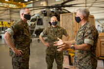 U.S. Marine Corps Col. Curtis Ebitz, commanding officer of Marine Corps Air Station New River, and Lt. Col. Roger Holliday, director of MCAS New River installations and environment, escort Maj. Gen. Edward D. Banta, commanding general of Marine Corps Installations Command, through hangar AS-4109 on MCAS New River, July 13, 2020. Banta is visiting military installations in Eastern North Carolina to receive an update on military construction from installation leaders and view hurricane related repairs to facilities and family housing currently in progress. (U.S. Marine Corps photo by Sgt. Breanna
Weisenberger)