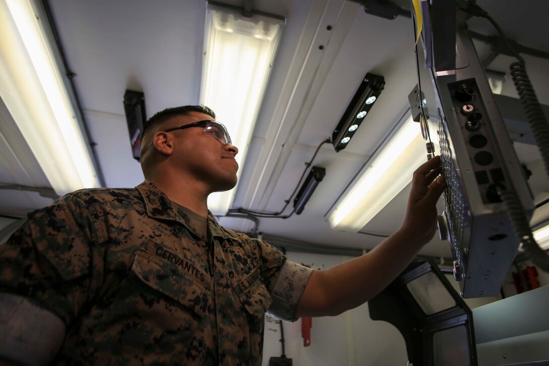 Staff Sgt. Victor Cervantes, the Digital Manufacturing Platoon staff non-commissioned officer in charge with Ordnance Maintenance Company, 1st Marine Logistics Group, operates a machine used to mil metal on Camp Pendleton, California, June 25, 2020. For his role in the development and fabrication of an efficient oxygen manifold that can provide oxygen to multiple patients from one tank, Cervantes received the 1st MLG Innovation Award from 1st MLG Commanding General Brig. Gen. Bobbi Shea. (U.S. Marine Corps photo by Pfc. Ulises Salgado)