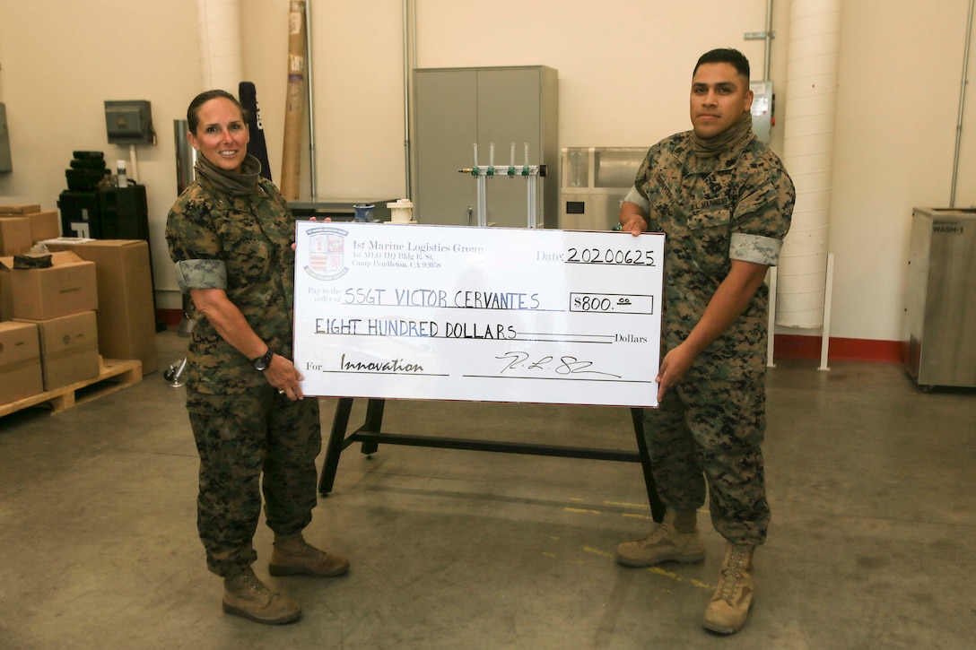 For his role in the development and fabrication of an efficient oxygen manifold that can provide oxygen to multiple patients from one tank, Staff Sgt. Victor Cervantes received the 1st Marine Logistics Group Innovation Award from 1st MLG Commanding General Brig. Gen. Bobbi Shea on Camp Pendleton, California, June 25, 2020. Cervantes is the Digital Manufacturing Platoon staff non-commissioned officer in charge with Ordnance Maintenance Company, 1st Maintenance Battalion, 1st MLG. (U.S. Marine Corps photo by Pfc. Ulises Salgado)