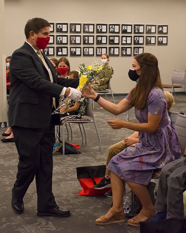 John Drake, Albuquerque District deputy district engineer, presents yellow roses to Patricia Stevens, wife of incoming district commander Lt. Col. Stevens, during the change of command ceremony, July 9, 2020, at the district office. Yellow is a sign of welcome and new beginnings. The budding flowers represent the anticipation of things to come.