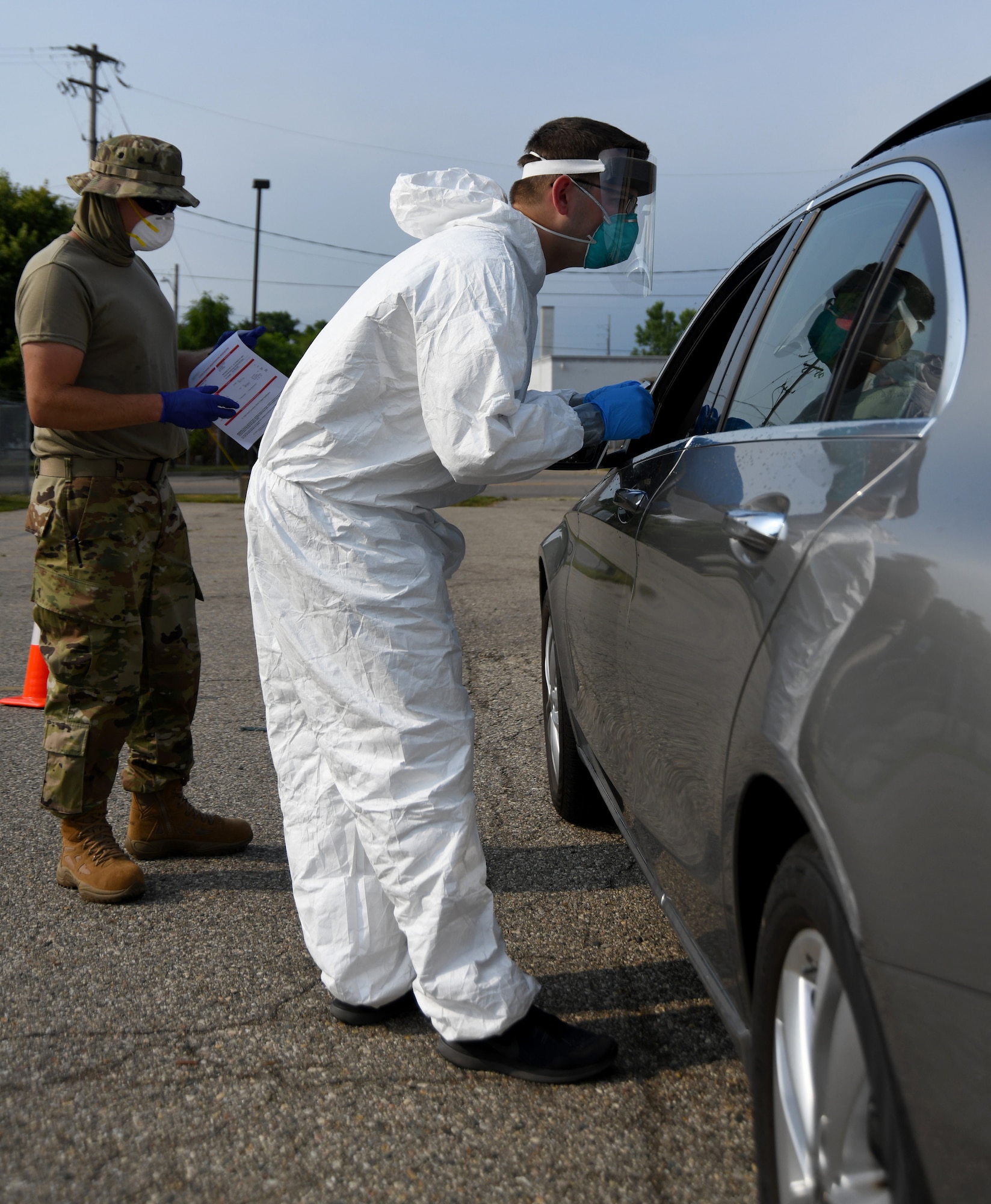 A member of the Michigan Air National Guard prepares to administer a COVID-19 test during drive-thru testing in Flint, Mich., July 10, 2020. The Michigan National Guard has partnered with a variety of state agencies to provide free tests to Michigan residents.