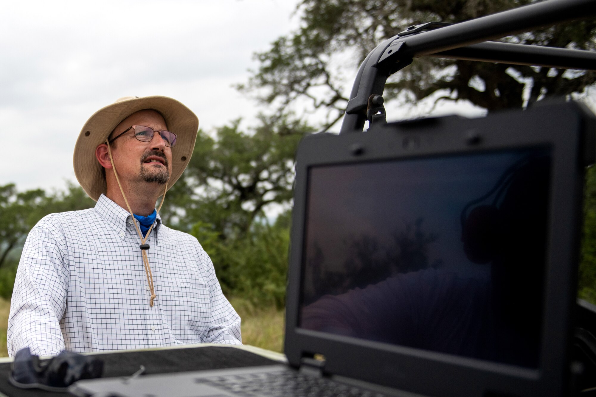 Paul Jurena, Air Force Civil Engineer Center natural resources specialist, watches as an unmanned aerial system flies during a test flight July 9, 2020, at Joint Base San Antonio-Camp Bullis, Texas.