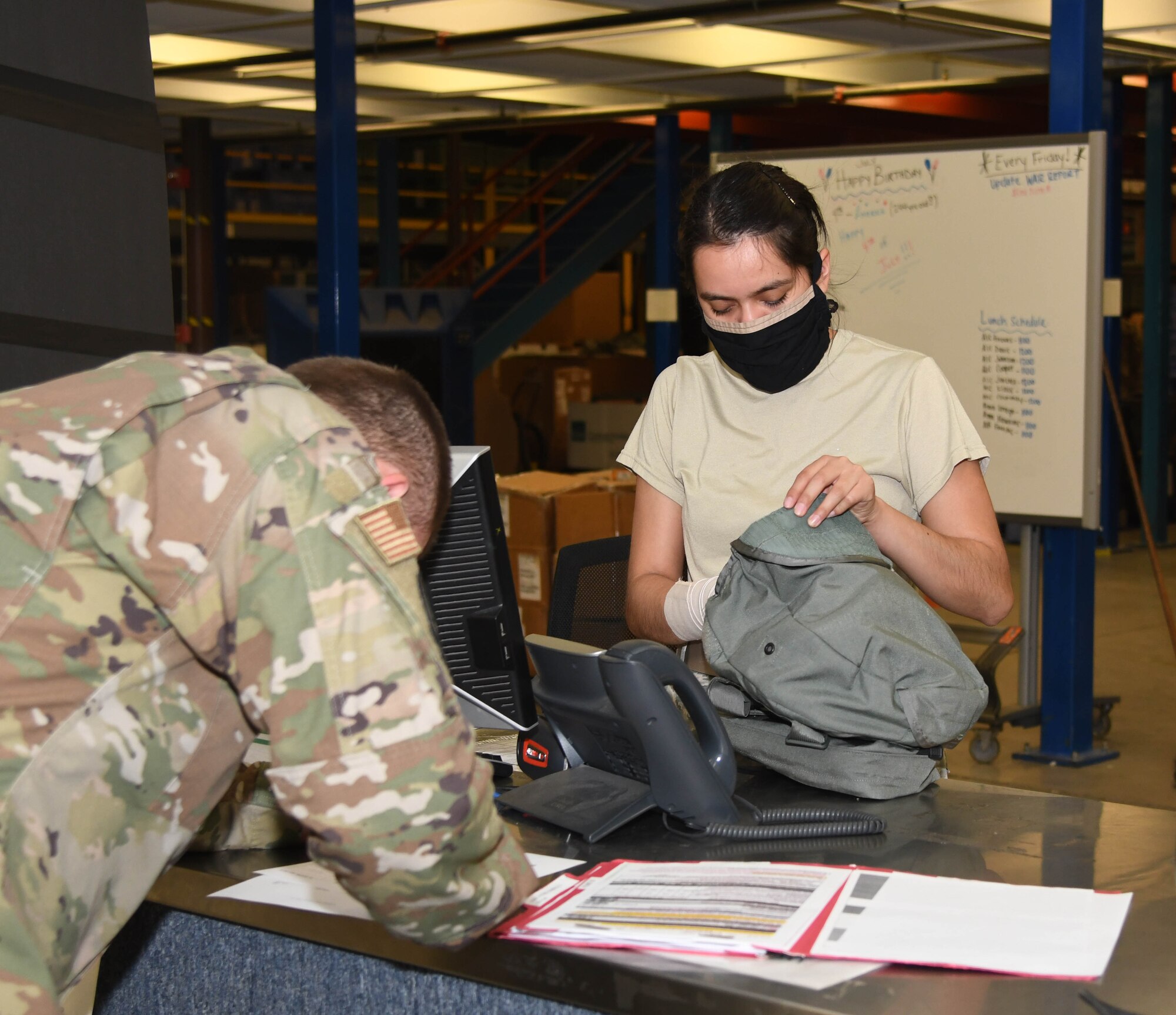 A photo of an Airman getting equipment.