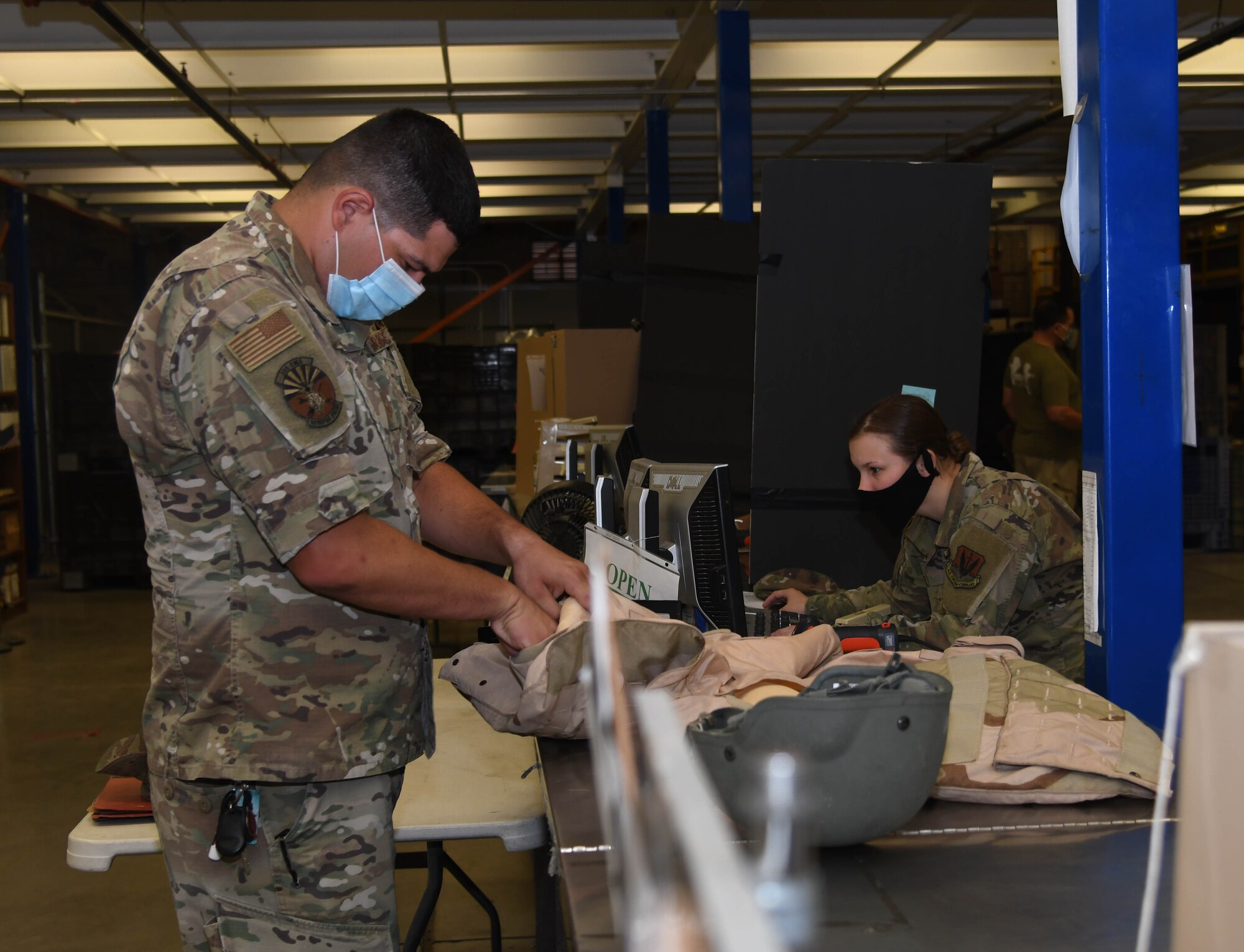 A photo of an Airman getting equipment.