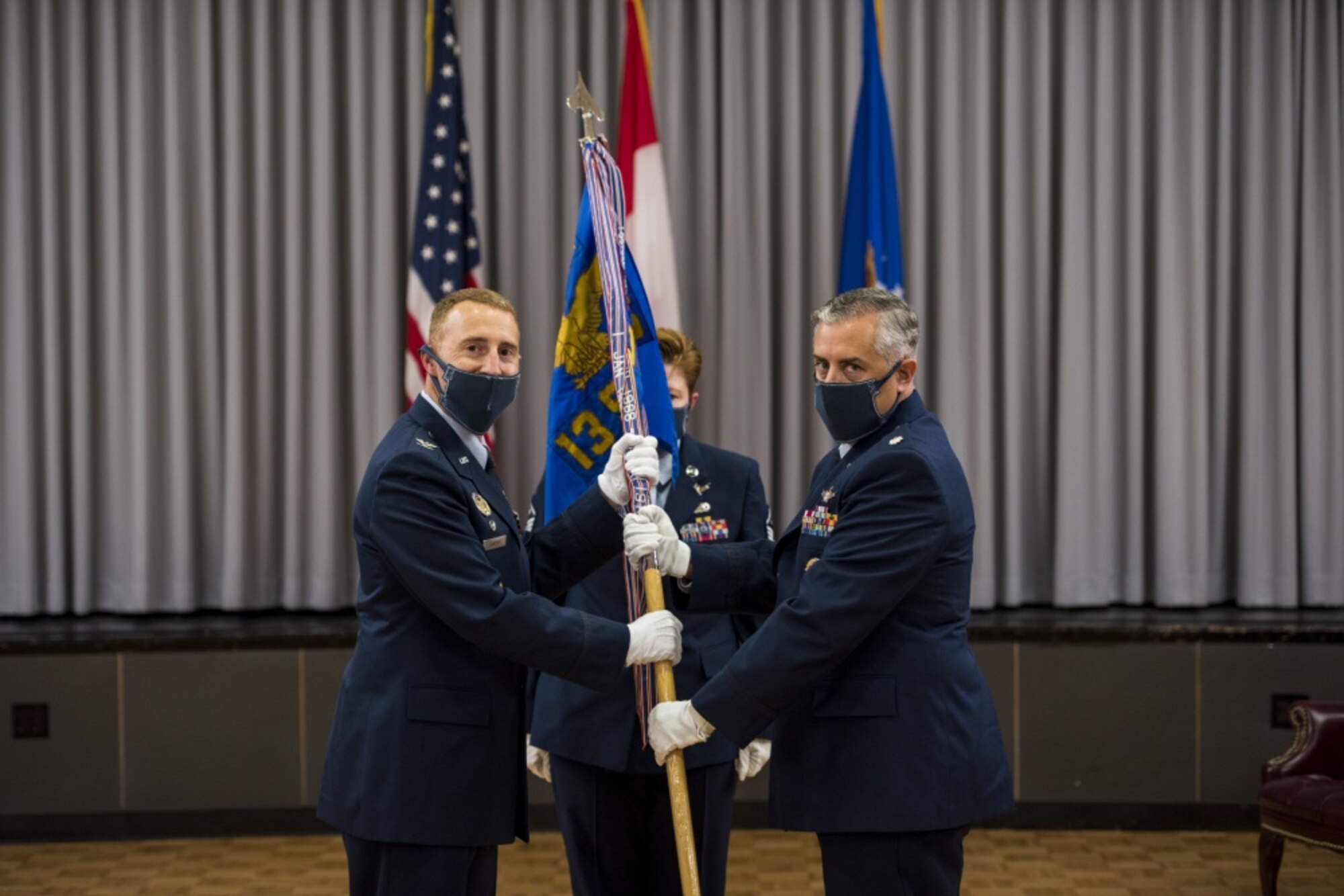 Lt. Col. Shahn Rashid accepts command of the 13th Space Warning Squadron from 21st Operations Group commander, Col. Matthew Cantore, July 2, 2020, at Clear Air Force Station, Alaska. The 13th SWS, along with the 213th SWS, Alaska Air National Guard, provide missile warning and defense, space domain awareness, and combat capabilities to North American Aerospace Defense Command, U.S. Northern Command, U.S. Strategic Command and U.S. Space Command. (U.S. Air National Guard photo by Tech. Sgt. Adam Keele)