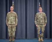 Col. Michael Miller, 2nd Bomb Wing commander, and Col. Christopher Hudson, outgoing 2nd Medical Group commander, stand at attention while Hudson receives the Legion of Merit Medal during a change of command ceremony at Barksdale Air Force Base, La., July 10, 2020.