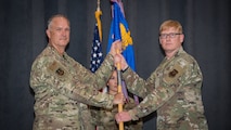 Col. Christopher Hudson, right, outgoing 2nd Medical Group commander, relinquishes the guidon to Col. Michael A. Miller, left, 2nd Bomb Wing commander, during a change of command ceremony at Barksdale Air Force Base, La., July 10, 2020. The passing of the guidon symbolizes a transfer of command.