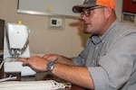 Norfolk Naval Shipyard (NNSY) Nuclear Operations (Code 300N) Assistant Project Superintendent Stephen Dougherty makes facemasks for his project team members in Kings Bay, Georgia.