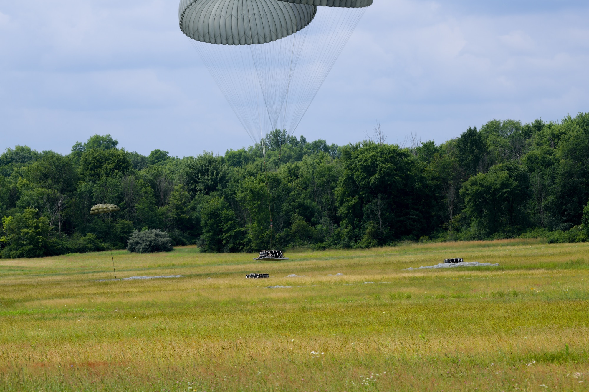 A 76th Aerial Port heavy cargo drop lands in Camp Garfield’s drop zone, July 12, 2020. Airmen from the 757th Airlift Squadron and the 76th Aerial Port Squadron were participating in cargo drop and drop zone training over the July unit training assembly.