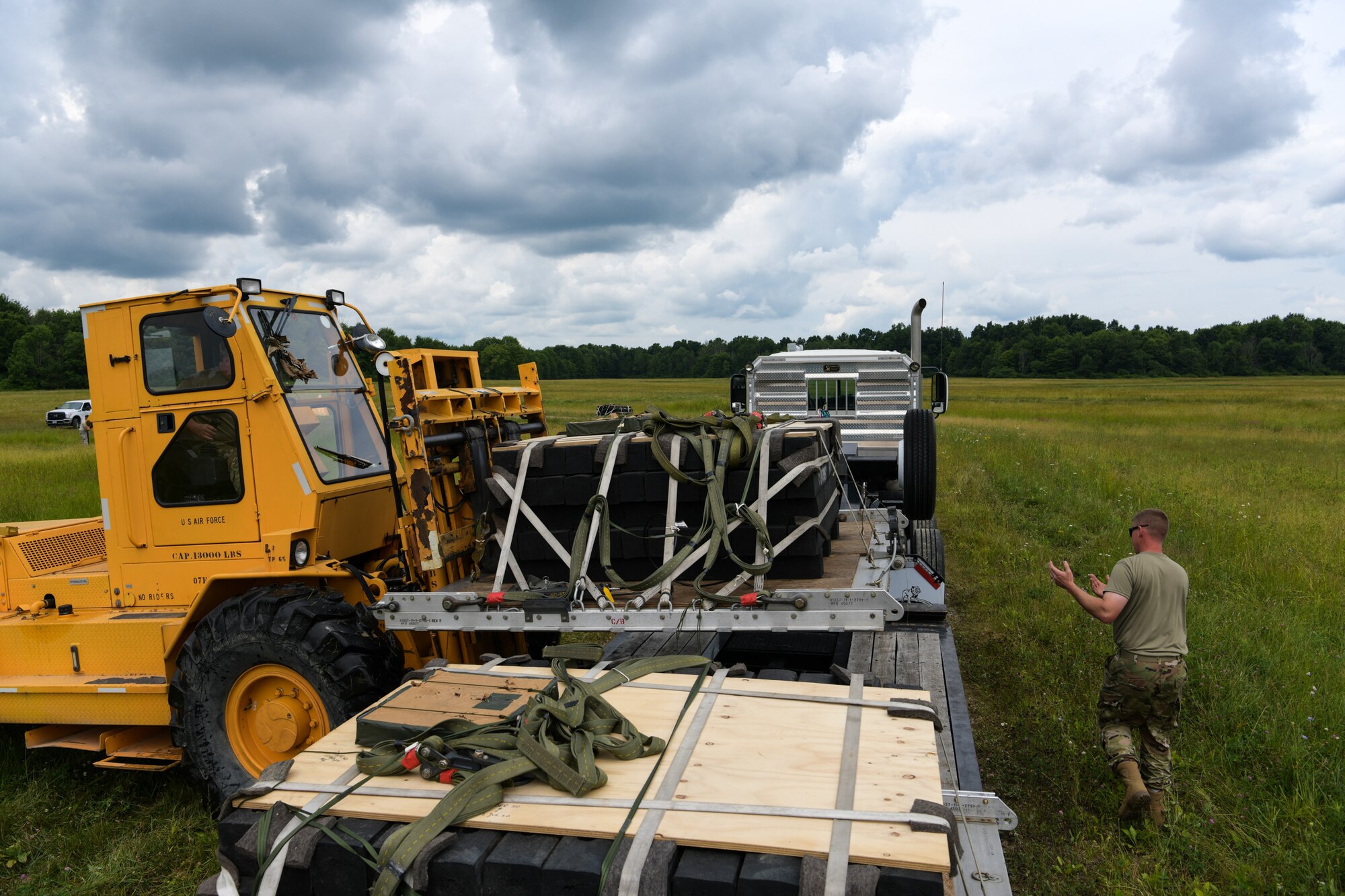 Master Sgt. Brad Franken and Tech. Sgt. Brandon Harrah, “port dawgs” with the 76th Aerial Port Squadron, load a heavy cargo drop onto a truck on Camp Garfield’s drop zone, July 12, 2020. Airmen from the 757th Airlift Squadron and the 76th Aerial Port Squadron were participating in cargo drop and drop zone training over the July unit training assembly.