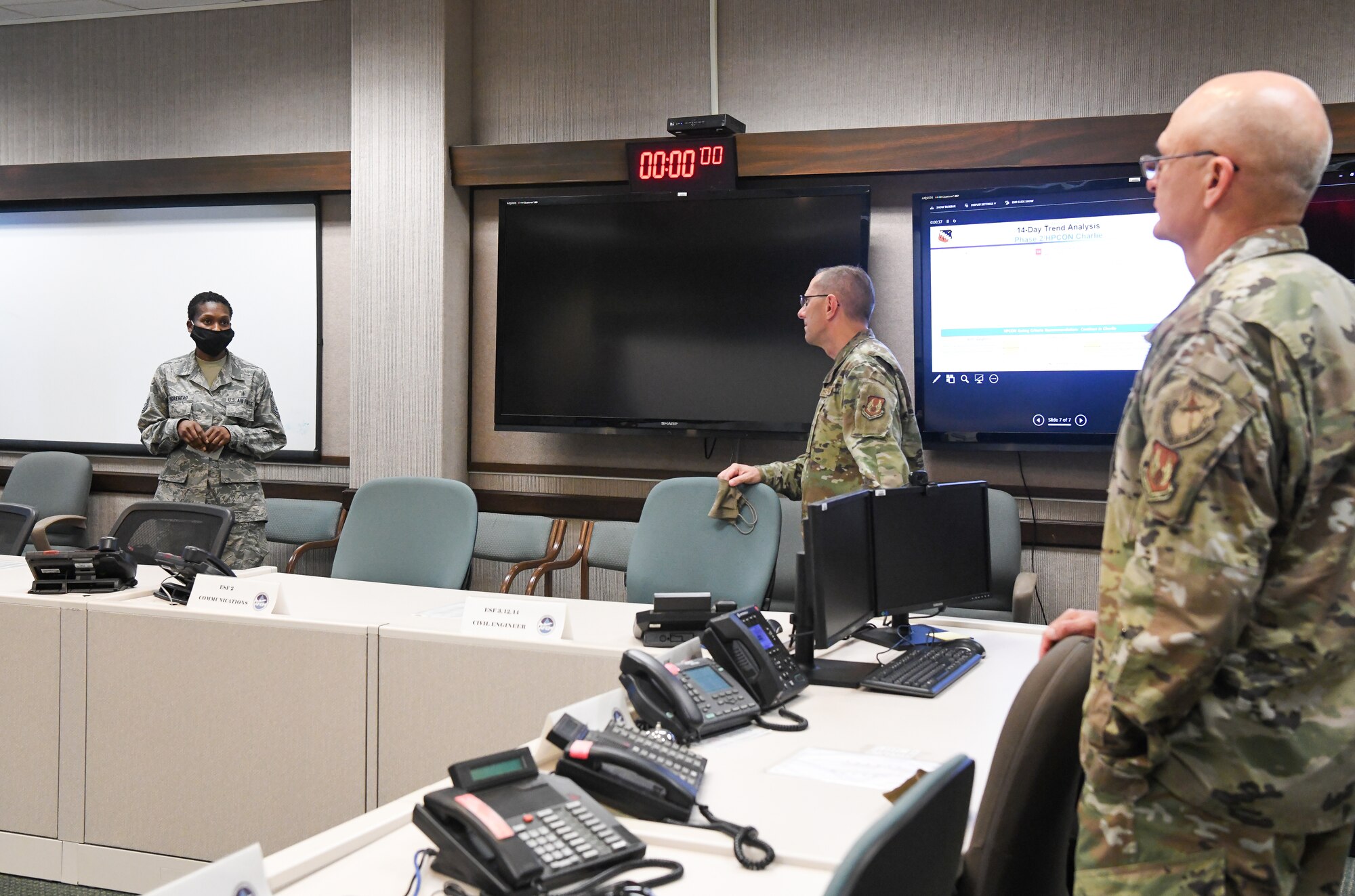 Master Sgt. Lashonda Morehead, left, flight chief of medical operations at Arnold Air Force Base, briefs Gen. Arnold W. Bunch Jr., right, commander, Air Force Materiel Command, and Chief Master Sgt. Stanley Cadell, command chief, Air Force Materiel Command, about the COVID-19 response at Arnold AFB, Tenn., headquarters of Arnold Engineering Development Complex, July 8, 2020. (U.S. Air Force photo by Jill Pickett)