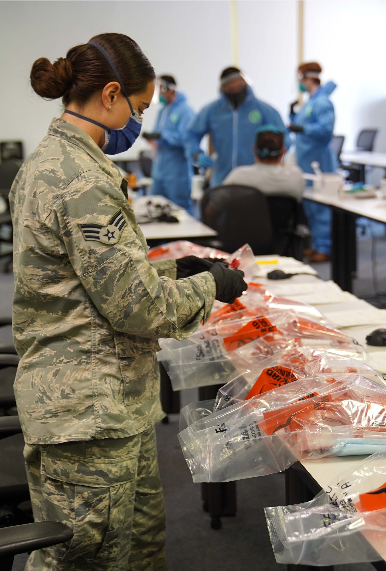 U.S. Air Force Senior Airman Brook Lee, 81st Diagnostic and Therapeutics Squadron laboratory technician, organizes samples for COVID-19 testing at the Combat Readiness Training Center in Gulfport, Mississippi, July 14, 2020. Airmen from Keesler Air Force Base assisted in testing over 900 Sailors as a part of the joint and total force effort across Navy and Air Force active duty and guard installations along the Gulf Coast. (U.S. Air Force photo by Airman 1st Class Kimberly L. Mueller)
