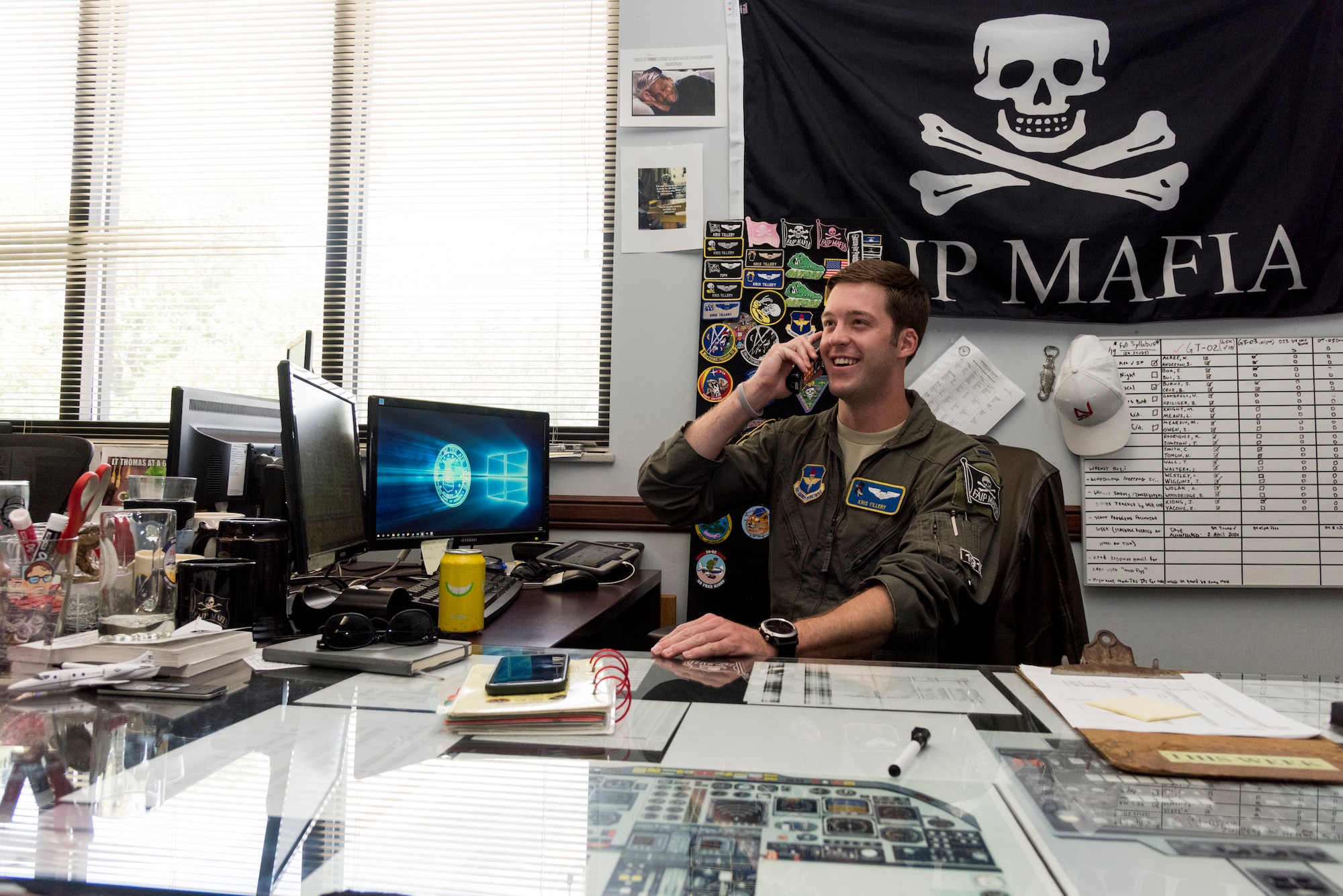 First Lt. Kristopher Tillery, 86th Flying Training Squadron instructor pilot, makes a phone call at the office, June 25, 2020 at Laughlin Air Force Base, Texas. Lt. Col. Shawn Chaney, 86th FTS director of operations, said, "It's been amazing seeing our squadron balance quarantine and COVID-19 prevention, while pushing forward with the mission; we're becoming better through this." (U.S. Air Force photo by Senior Airman Anne McCready)