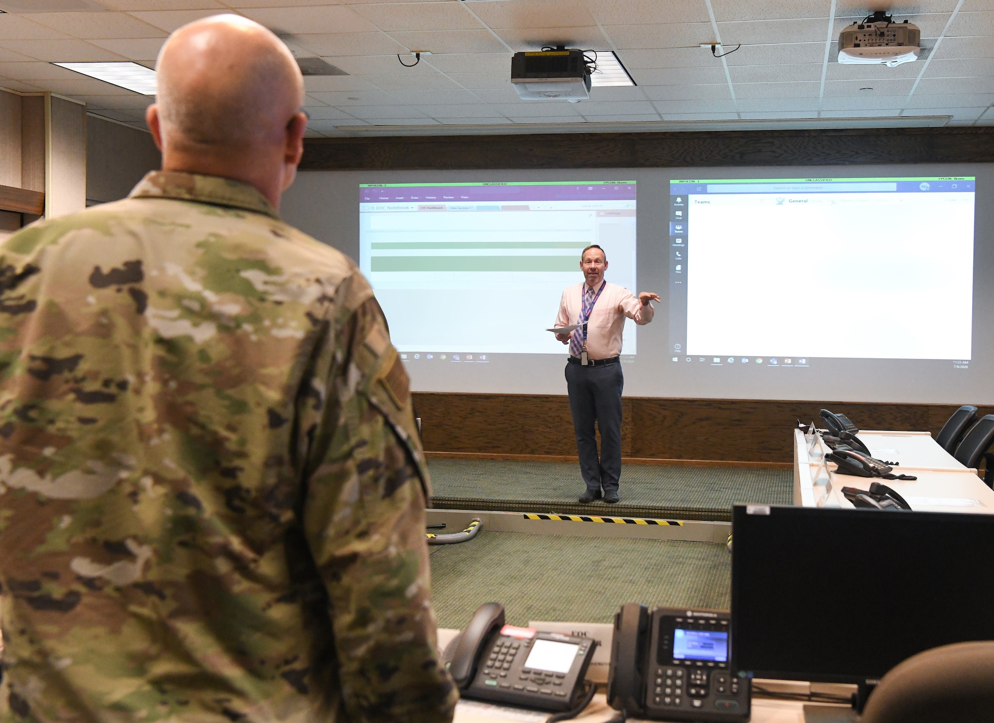 James Dill, chief of Arnold Engineering Development Complex (AEDC) emergency management, briefs Gen. Arnold W. Bunch Jr., commander, Air Force Materiel Command, about COVID-19 response at Arnold Air Force Base, Tenn., headquarters of AEDC, July 8, 2020. (U.S. Air Force photo by Jill Pickett) (This image was altered by obscuring images for security purposes.)