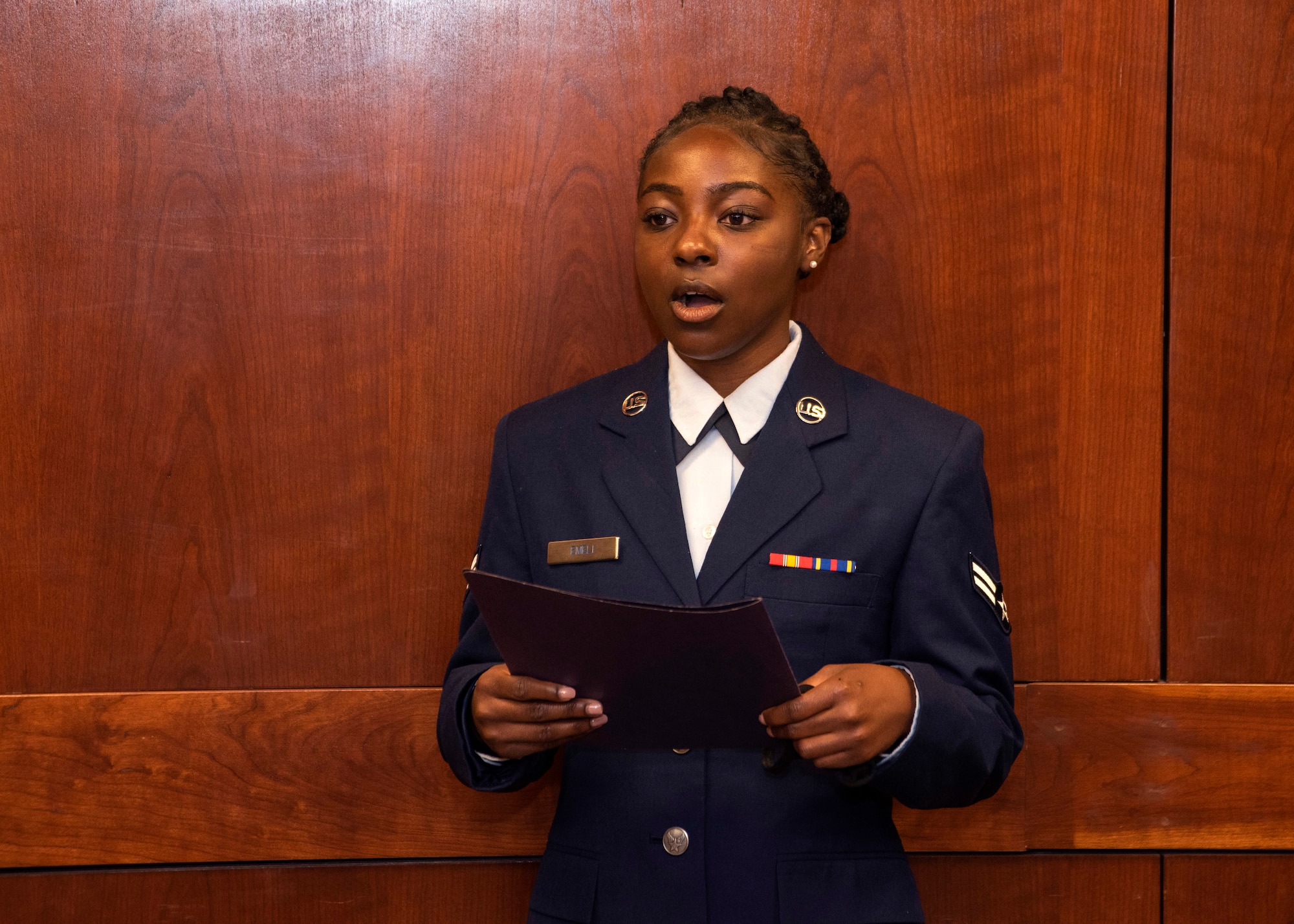 U.S. Air Force Airman 1st Class Victoria Emeli, a 673d Contracting Squadron contract specialist, sings the national anthem during the 673d Air Base Wing change of command ceremony at Joint Base Elmendorf-Richardson, Alaska, July 14, 2020. The 673d ABW is composed of a command section, the 673d Comptroller Squadron, and four groups; the 673d Mission Support Group, the 673d Medical Group, 673d Civil Engineer Group, and the 673d Logistics Readiness Group. These are the primary organizations responsible for providing installation management functions to ensure JBER remains America's premier strategic power projection platform. The wing supports and enables three AF total-force wings, one Army brigade and 55 tenant units. The change of command ceremony was adapted to comply with COVID-19 health and safety measures.