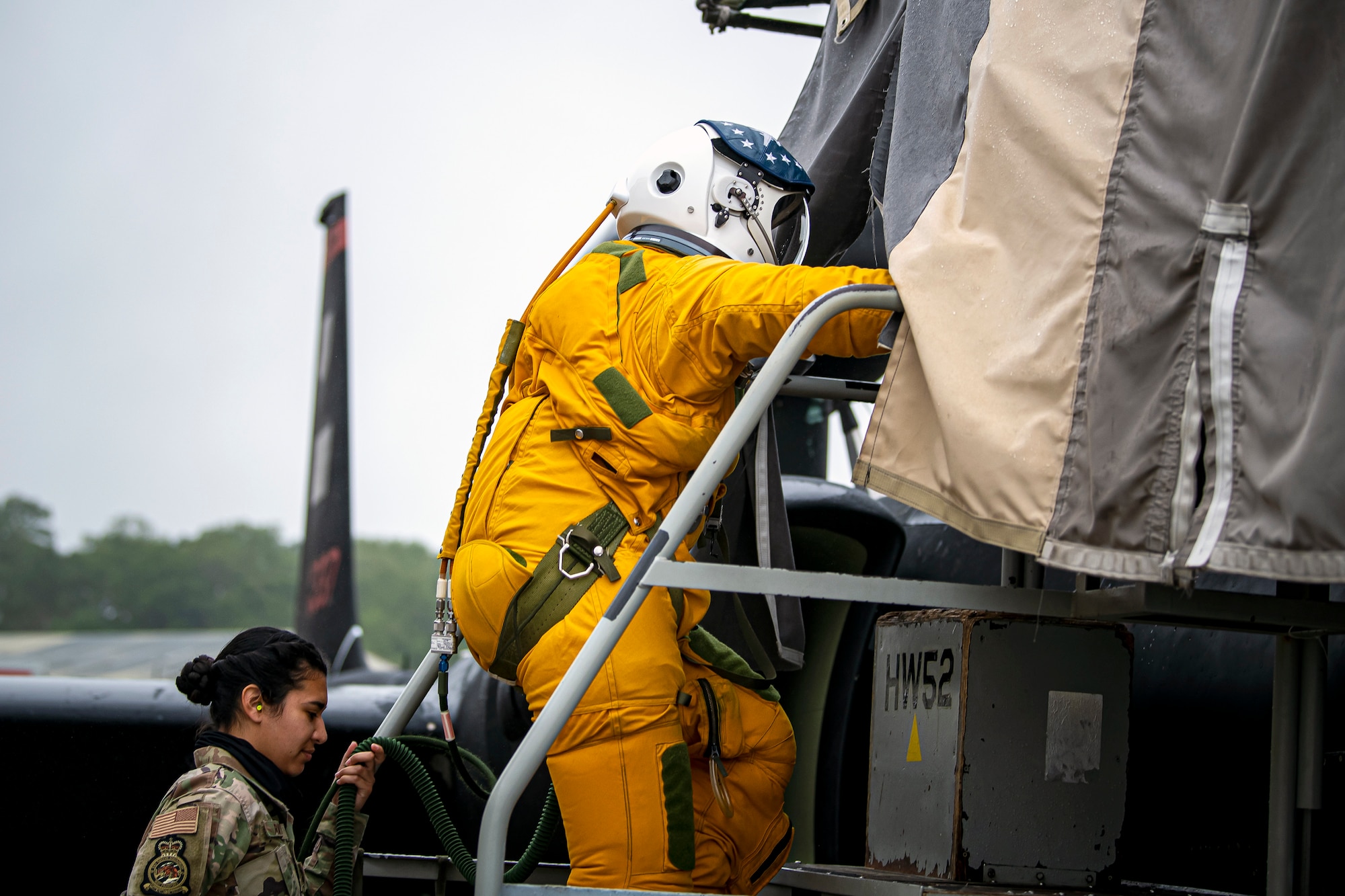 U.S. Air Force Capt. Joshua Hall, right, 99th Reconnaissance Squadron (ERS) U-2 Dragon Lady pilot, climbs into the cockpit of a U-2 aircraft while Senior Airman Cynthia Rivera, 99th ERS physiology support technician, helps transport his oxygen at RAF Fairford, England, July 8, 2020. The U-2 aircraft assigned to the 9th Reconnaissance Wing, Beale Air Force Base, Calif., are currently deployed to RAF Fairford as part of the 99th ERS. The aircraft supplements a variety of missions that enhance regional and global security in support of U.S. and NATO allies and regional partners. (U.S. Air Force photo by Senior Airman Eugene Oliver)