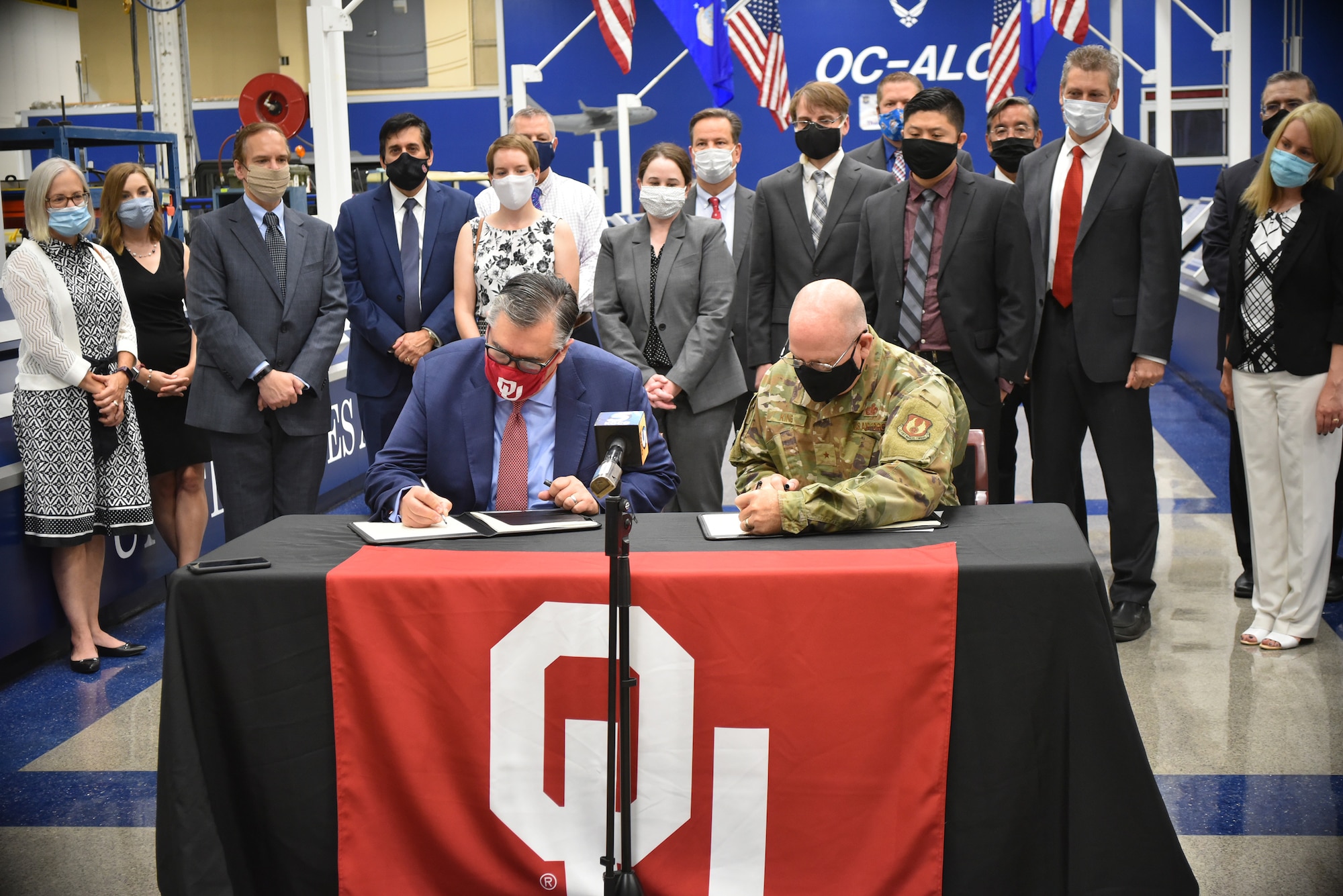 Dr. Tomás Díaz de la Rubia, University of Oklahoma vice president for Research and Partnerships, left, and Brig. Gen. Jeffrey R. King, Oklahoma City Air Logistics Complex commander, sign an Educational Partnership Agreement July 14, 2020. The agreement will help both institutions cultivate aerospace technology development and will improve and enhance education in science, technology, engineering, and mathematics at the university. (Air Force photo by April McDonald)