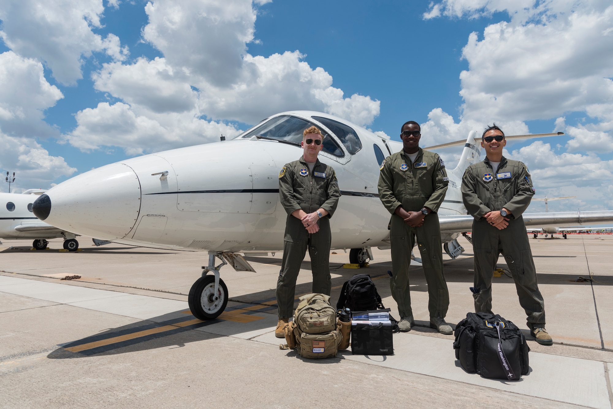 Capt. Jarod Washington, 86th Flying Training Squadron instructor pilot, and 47th Student Squadron student pilots, Capt. Micheal Magtalas and 2nd Lt. Jake Marino, stand on the flightline before a flight, June 25, 2020 at Laughlin Air Force Base, Texas. what are some examples of training missions do you all fly?(U.S. Air Force photo by Senior Airman Anne McCready)