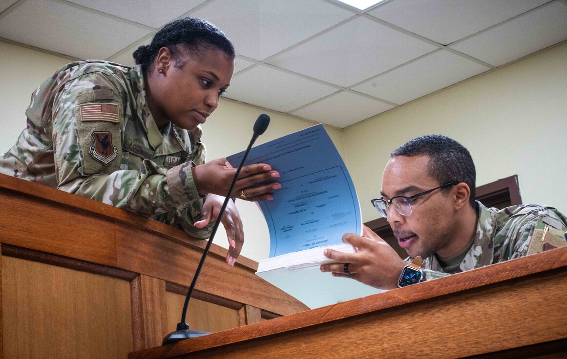 Airman from the 18th Wing Office of the Staff Judge Advocate review case files in the court room at Kadena Air base.
