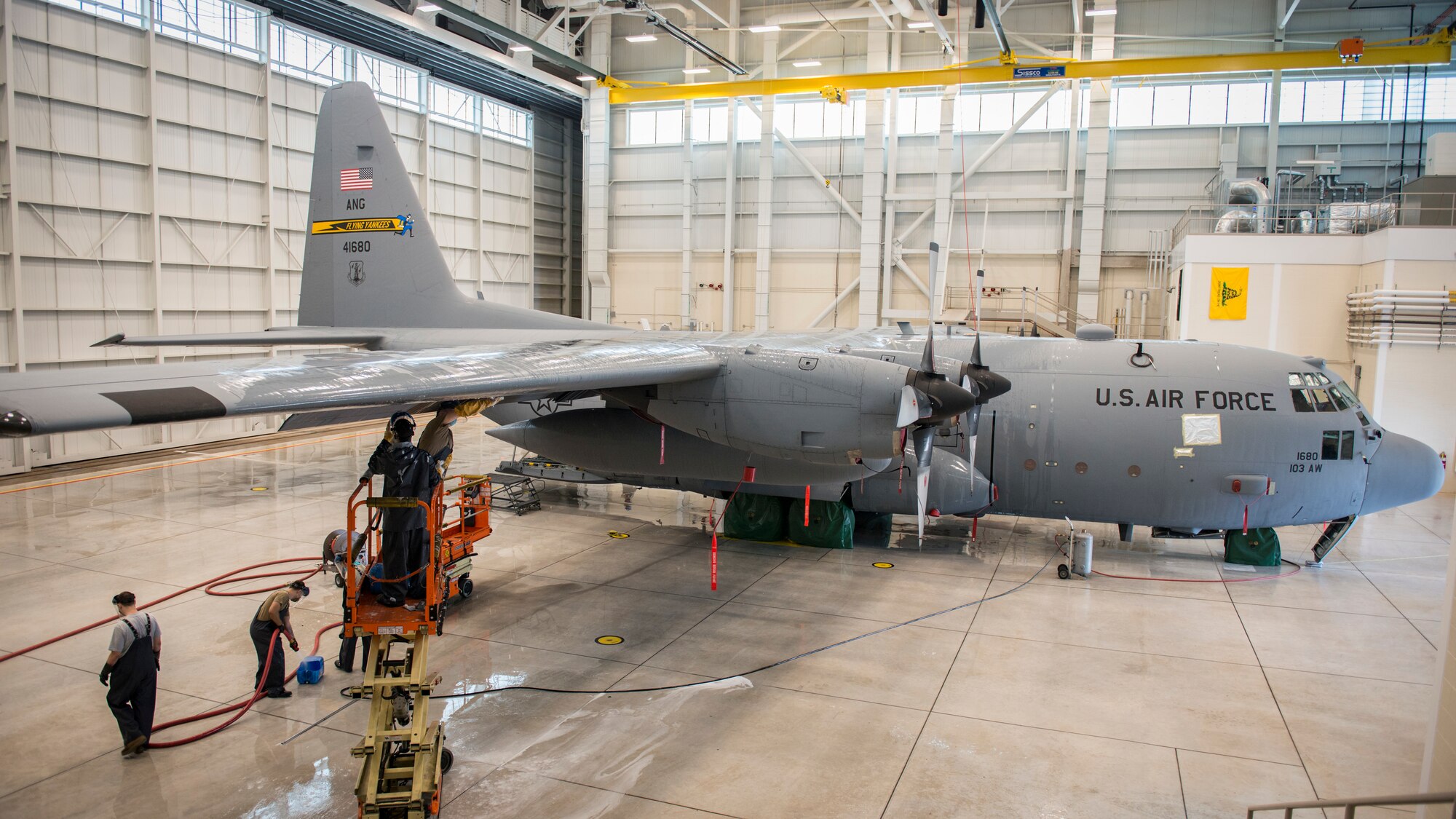 Airmen from the 103rd Maintenance Group wash a C-130H Hercules at the Bradley Air National Guard Base fuel cell and corrosion control facility in East Granby, Connecticut, July 13, 2020. Each of the 103rd Airlift Wing’s eight C-130 aircraft are washed every six months to clean contaminants and prevent corrosion, ensuring aircraft readiness and extending its life cycle. (U.S. Air National Guard photo by Staff Sgt. Steven Tucker)
