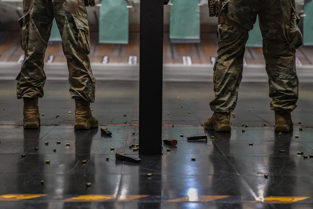 Tech. Sgt. Jordan Corsonwalp, 31st Security Forces Squadron flight sergeant (left), and Tech. Sgt. Jeremiah Strickland, 31st SFS noncommissioned officer in charge of electronic security systems (right), shoot at a target during a Combat Arms Training and Maintenance class at Aviano Air Base, Italy, July 14, 2020. The M18 is a 9mm handgun and a lightweight version of the M17 SIG Sauer. The M18 handgun can be customized with a small, medium or large handgrip. (U.S. Air Force photo by Airman 1st Class Thomas S. Keisler IV)