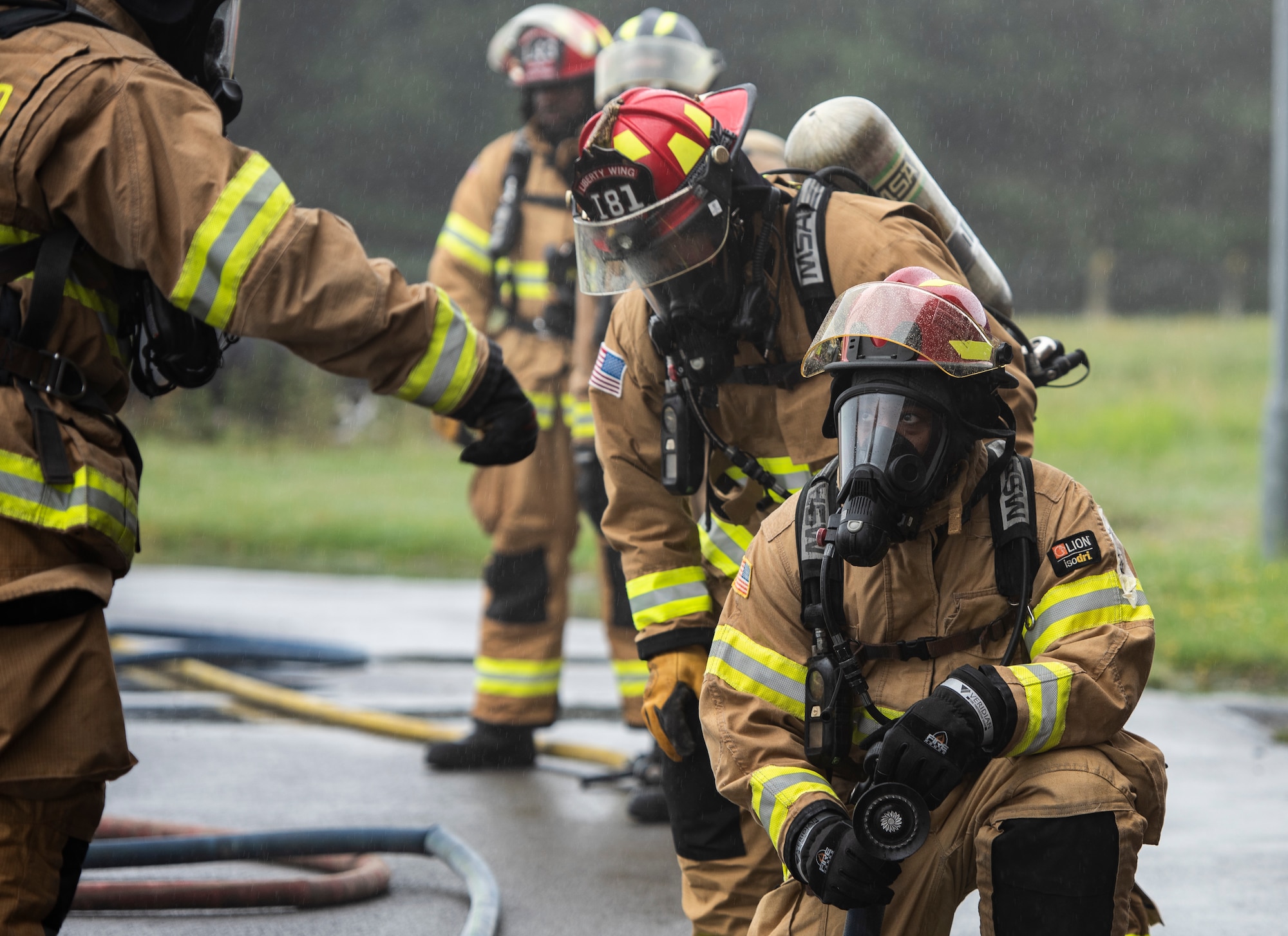 U.S. Air Force firefighters assigned to the 48th Civil Engineering Squadron prepare to participate in a controlled burn training exercise at Royal Air Force Lakenheath, England, July 8, 2020. Liberty wing firefighters participate in live fire and smoke training quarterly to ensure readiness for real-world situations. (U.S. Air Force photo by Airman 1st Class Jessi Monte)