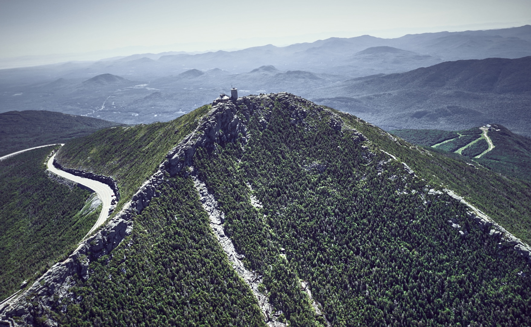 Aviators assigned to the New York Army National Guard's Army Aviation Support Facility #3, from Latham, N.Y., along with forest rangers and environmental conservation officers, scout locations for landing zones around Whiteface Mountain near Lake Placid, N.Y., July 6, 2020. The pilots are looking at using the rocky outcrops of the mountain to train with UH-60 Black Hawk helicopters.