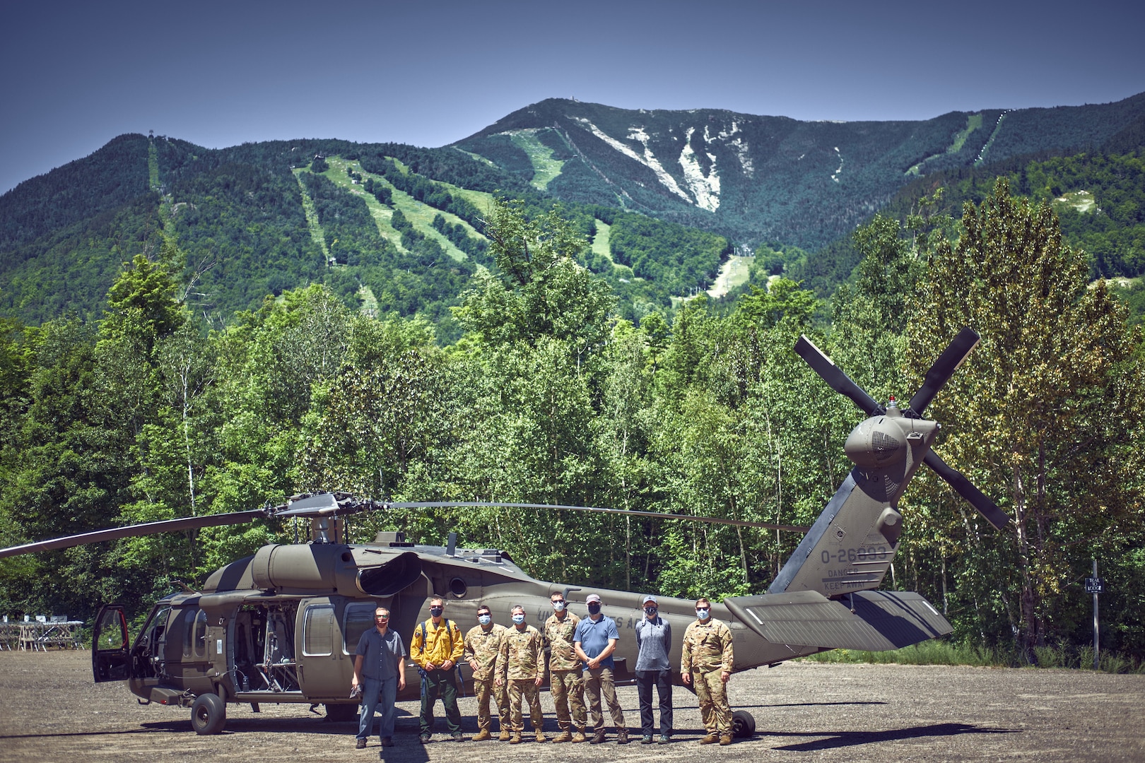 Aviators assigned to the New York Army National Guard's Army Aviation Support Facility #3, from Latham, N.Y., along with forest rangers and environmental conservation officers, scout locations for landing zones around Whiteface Mountain near Lake Placid, N.Y., July 6, 2020. The pilots are looking at using the rocky outcrops of the mountain to train with UH-60 Black Hawks helicopters.