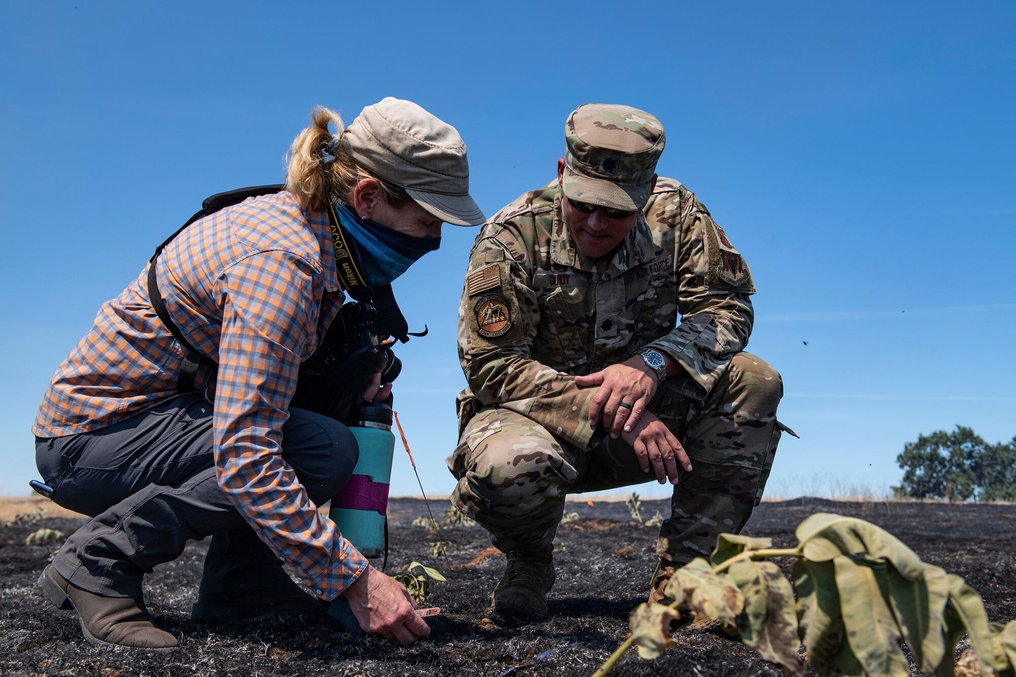 Jaymee Marty, ecologist shares findings from a prescribed fire with Lt. Col. Travis Guidt, 9th Civil Engineer Squadron commander, on Beale Air Force Base.