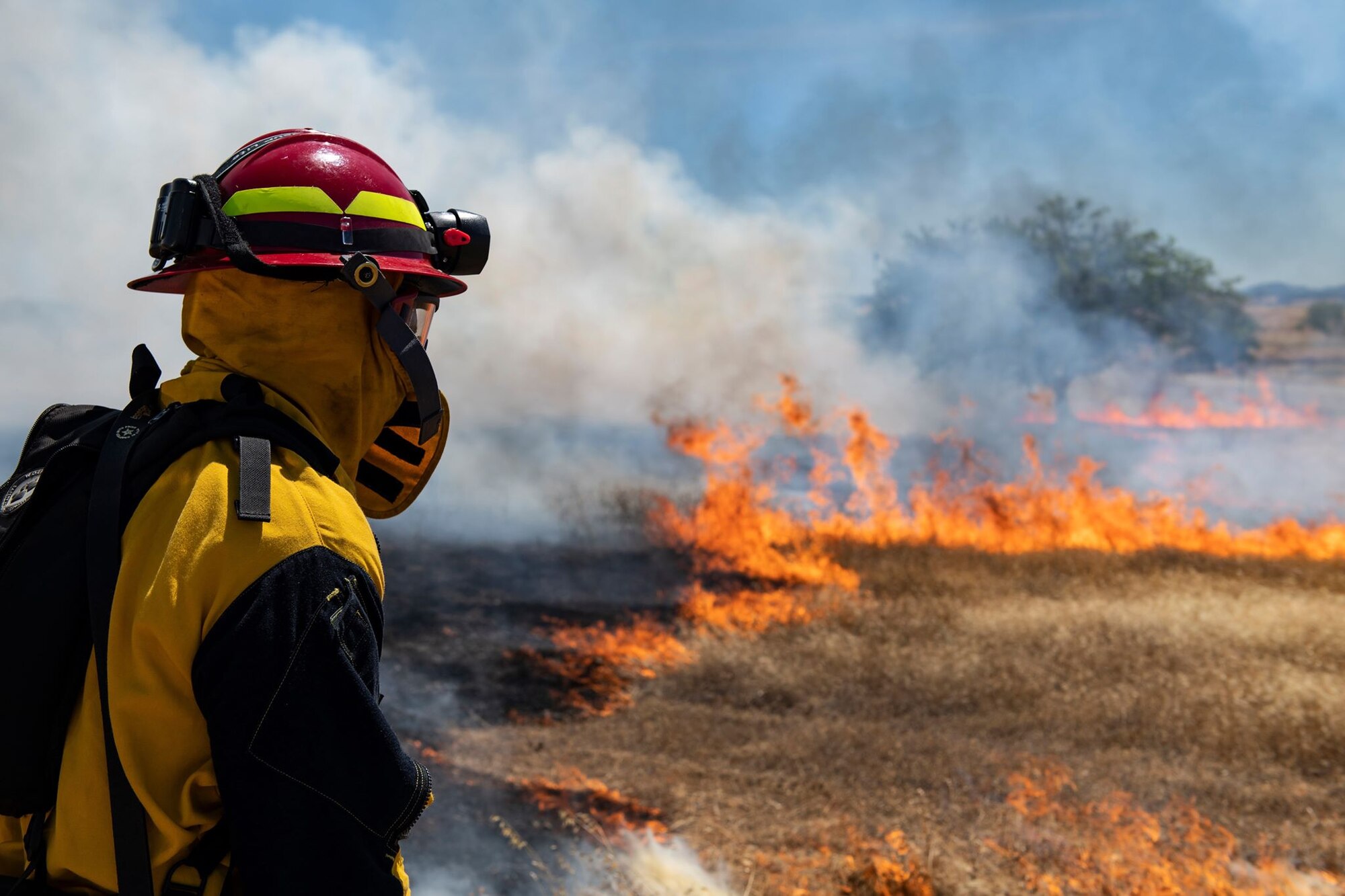 A 9th Civil Engineer Squadron firefighter observes a prescribed fire on Beale Air Force Base.