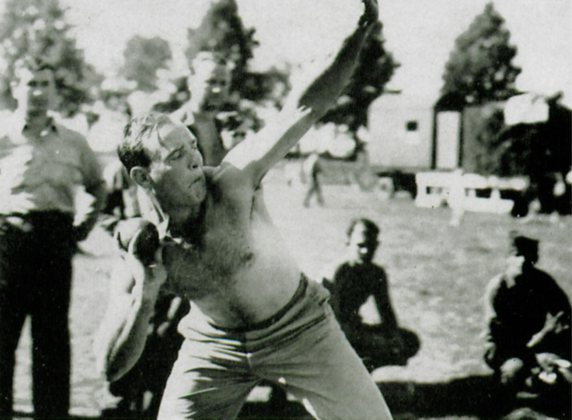 The “body beautiful” shown here in action during the group’s second anniversary track and field meet. (The Story of the 371st Fighter Group in the E.T.O.)