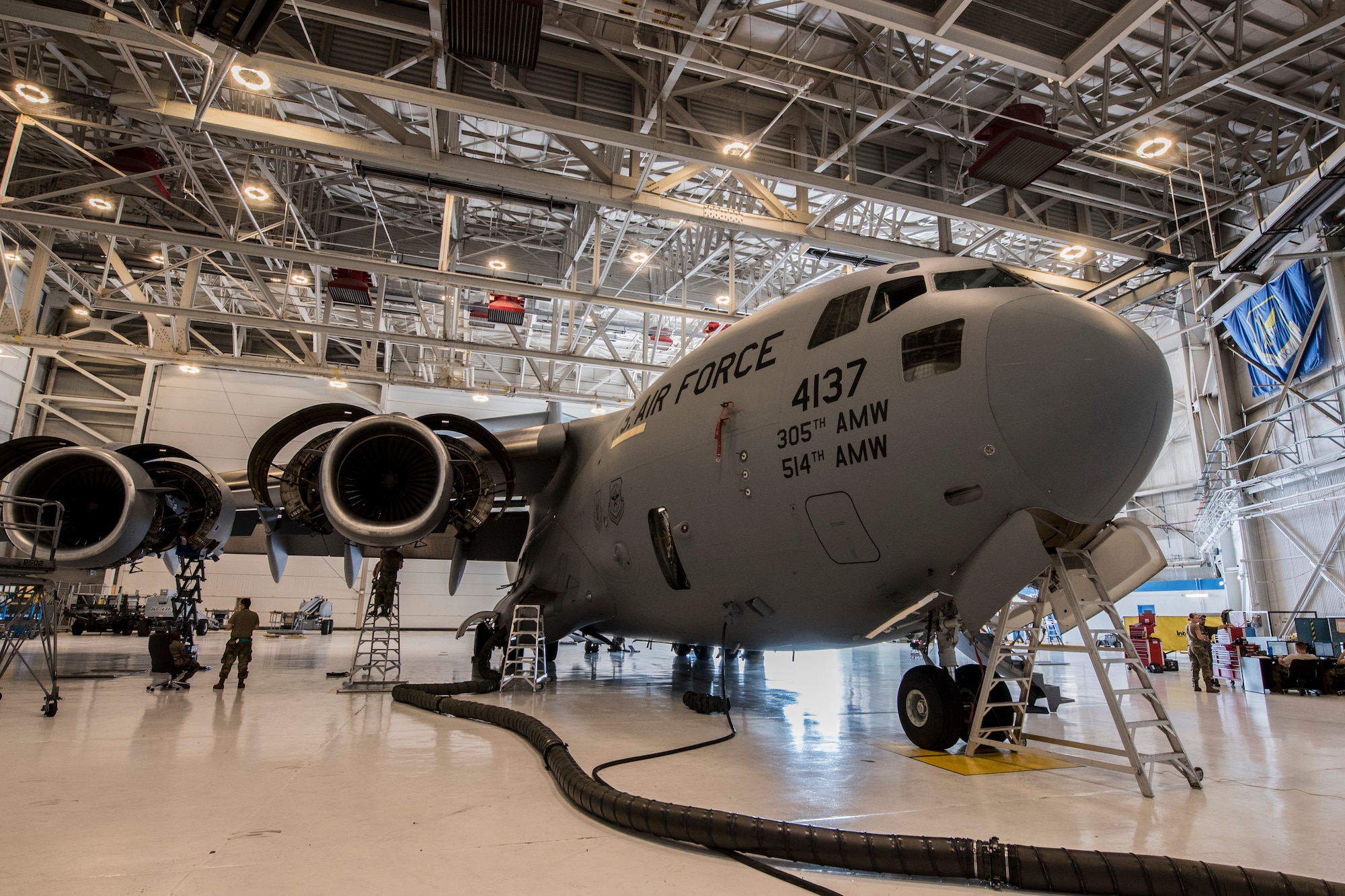 Photo of Airmen assigned to the 305th Maintenance Squadron performing an inspection on a C-17 Globemaster III.