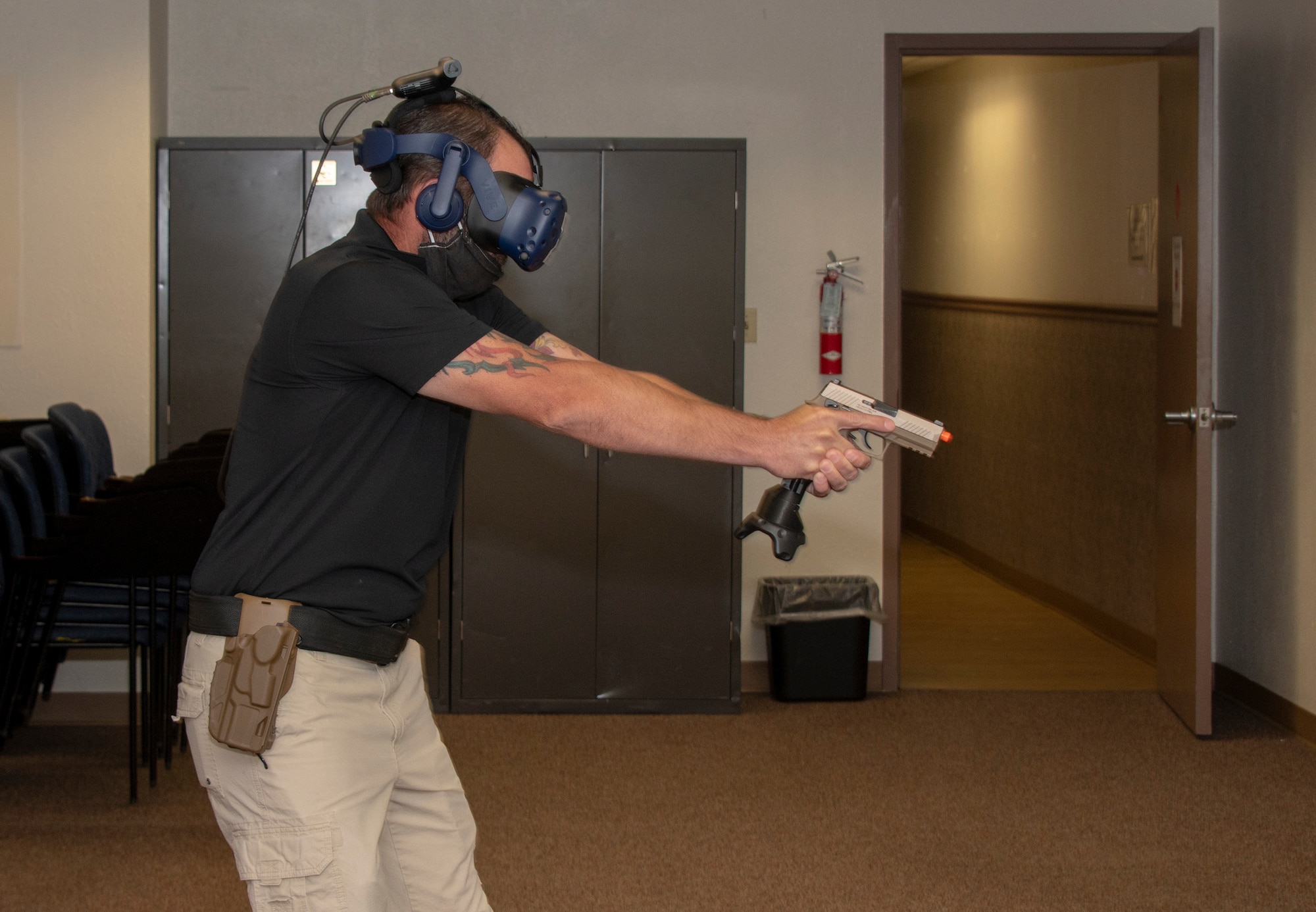 Brandon Feldman, 60th Security Forces Squadron training instructor, demonstrates virtual reality technology during Leadership Rounds July 10, 2020, at Travis Air Force Base, California. The 60th SFS uses this system to train and evaluate Airmen on use-of-force law enforcement technique. The Leadership Rounds program provides 60th AMW leadership an opportunity to interact with Airmen and get a detailed view of each mission performed at Travis AFB.  (U.S. Air Force photo by Heide Couch)
