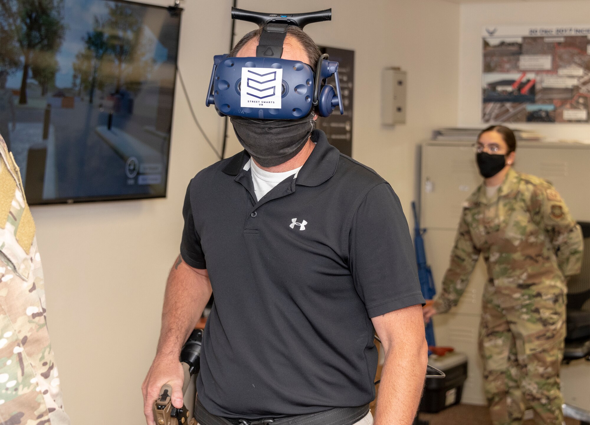 Brandon Feldman, 60th Security Forces Squadron training instructor, demonstrates virtual reality technology during Leadership Rounds July 10, 2020, at Travis Air Force Base, California. The 60th SFS uses this system to train and evaluate Airmen on use-of-force law enforcement technique.  The Leadership Rounds program provides 60th AMW leadership an opportunity to interact with Airmen and get a detailed view of each mission performed at Travis AFB. (U.S. Air Force photo by Heide Couch))