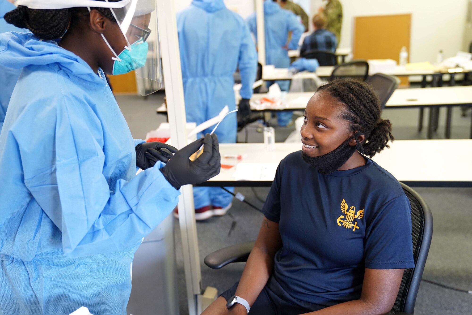 U.S. Air Force Airman 1st Class Arielle Williams, 81st Aerospace Medicine Squadron medical technician, prepares to collect a specimen from U.S. Navy Airman Apprentice Zorya Brown, USS Tripoli aviation Professional Apprenticeship Career Track, for COVID-19 testing at the Combat Readiness Training Center in Gulfport, Mississippi, July 14, 2020. Airmen from Keesler Air Force Base assisted in testing over 900 Sailors as a part of the joint and total force effort across Navy and Air Force active duty and guard installations along the Gulf Coast. (U.S. Air Force photo by Airman 1st Class Kimberly L. Mueller)