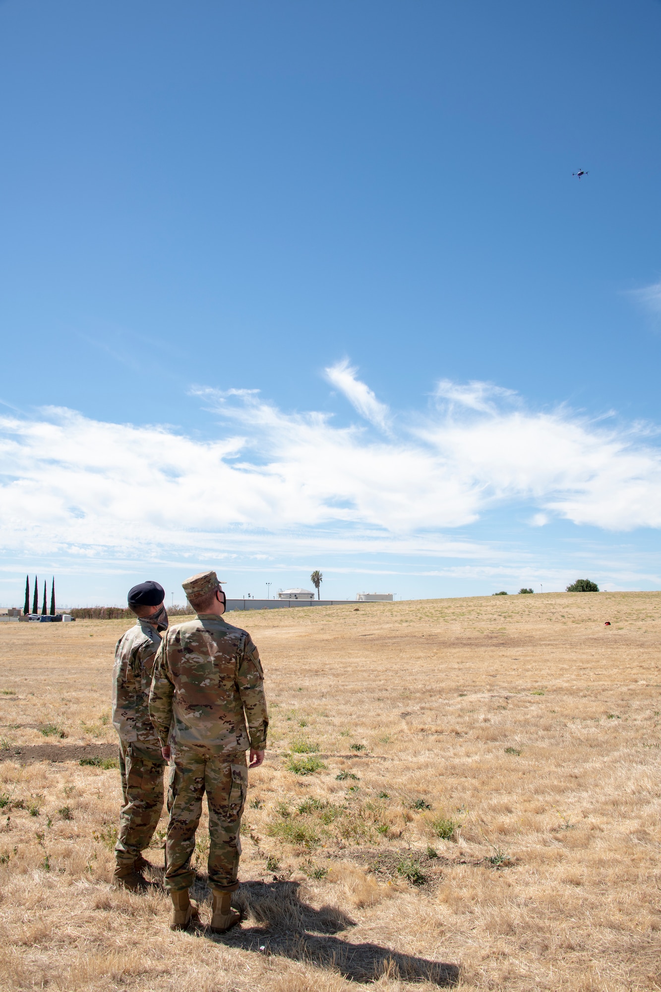 U.S. Air Force Airman Ezra Ashton, left, 60th Security Forces installation entry controller, and Col. Jeffrey Nelson, 60th Air Mobility Wing commander, watch a drone fly during Leadership Rounds July 10, 2020, at Travis Air Force Base, California. The mobile and fully autonomous drone-based monitoring system enhances 60th SFS incident management and physical security of the base. The Leadership Rounds program provides 60th AMW leadership an opportunity to interact with Airmen and get a detailed view of each mission performed at Travis AFB. (U.S. Air Force photo by Heide Couch